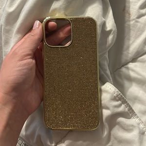 Beautiful gold colored bedazzled iPhone 12/13 pro max phone case.